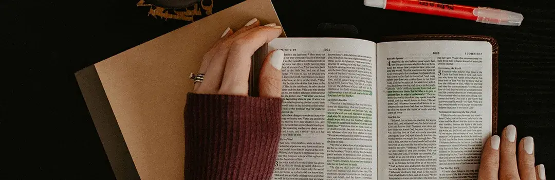 Woman highlighting verses in Bible