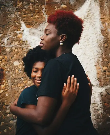 Woman hugging daughter