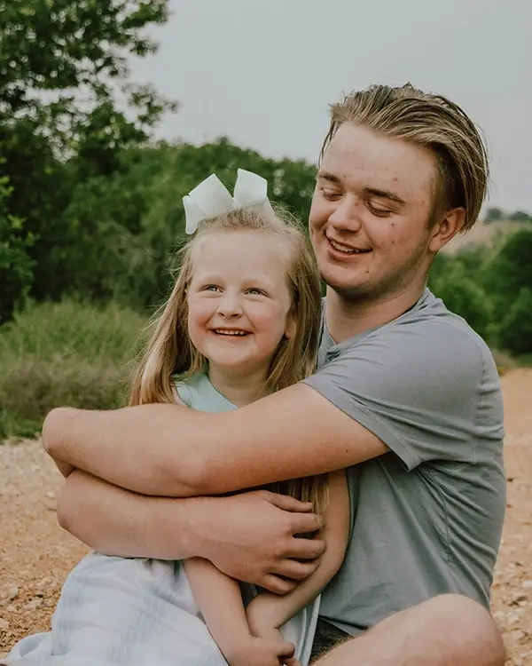 Brother and sister hugging