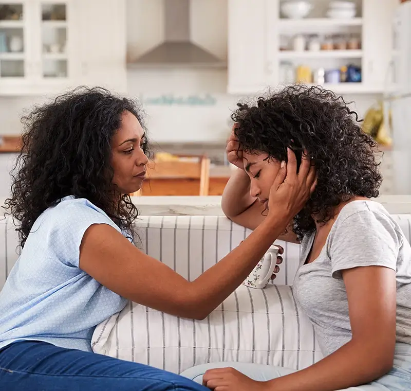 Mother comforting daughter