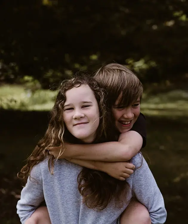 Sister carrying younger brother