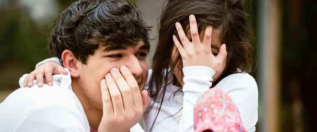 Brother and sister laughing together